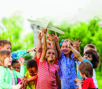 Close-up view of kids reaching after airplane toy